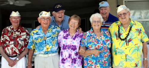 Pearl Harbor survivors and sweethearts share a smile. From left, Clarence “Bud” Boner, Walter Urmann, Bill Slater, Alice Darrow, Vanya Leighton, Henry Anderson and Jim Harris. Photo by Janeane Bogner.